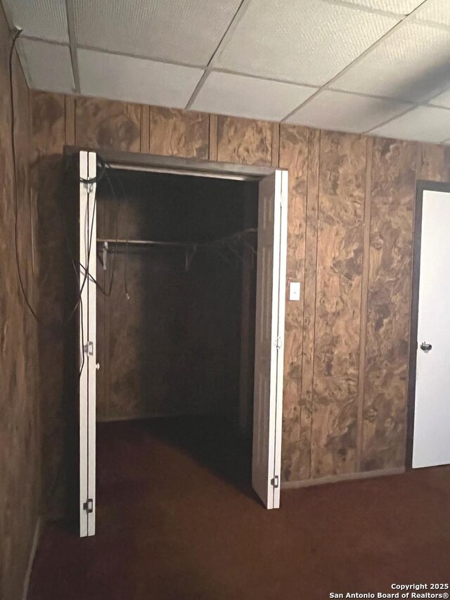 413 4th St, Poteet, TX 78065 - basement with wooden walls and a drop ceiling