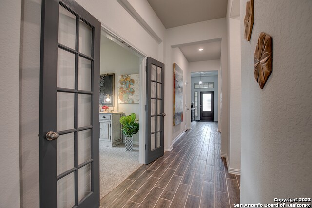 8952 San Carlos, Seguin, TX 78155 - hallway featuring dark wood-type flooring, french doors, baseboards, and recessed lighting