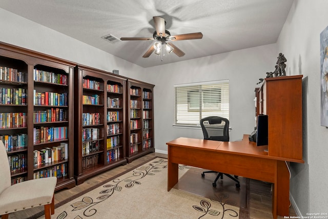 116 Cold Riv, Boerne, TX 78006 - office space with a ceiling fan, wood finished floors, and bookshelves