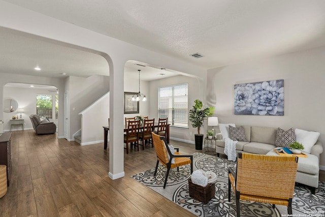 116 Cold Riv, Boerne, TX 78006 - living area with arched walkways, stairway, wood finished floors, plenty of natural light, and recessed lighting