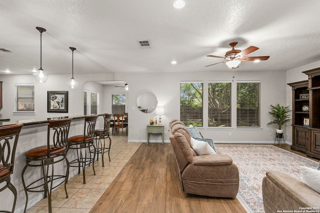 116 Cold Riv, Boerne, TX 78006 - living area featuring ceiling fan, arched walkways, light wood-type flooring, recessed lighting, and a textured ceiling