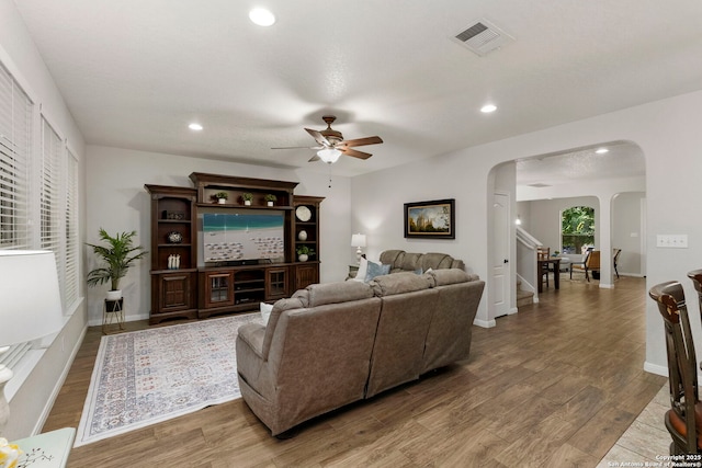116 Cold Riv, Boerne, TX 78006 - living room with arched walkways, a ceiling fan, wood finished floors, and recessed lighting