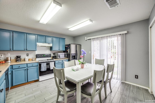 2111 Clear Ct, San Antonio, TX 78227 - kitchen featuring white electric stove, blue cabinetry, under cabinet range hood, wood tiled floors, and a textured ceiling