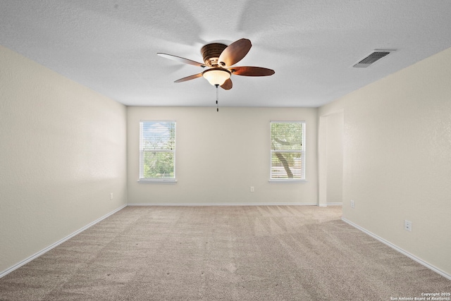 220 Hinge, Cibolo, TX 78108 - carpeted empty room featuring a ceiling fan, healthy amount of natural light, and a textured ceiling