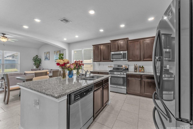 8919 Ladbroke, Converse, TX 78109 - kitchen with stainless steel appliances, recessed lighting, tasteful backsplash, light stone countertops, and dark brown cabinetry