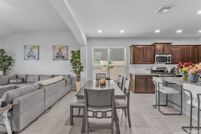 8919 Ladbroke, Converse, TX 78109 - kitchen with appliances with stainless steel finishes, open floor plan, light stone counters, decorative backsplash, and recessed lighting