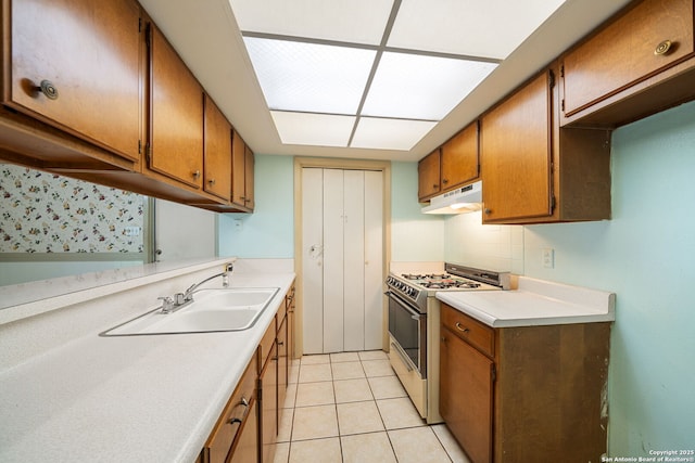7022 Centergrove Dr, San Antonio, TX 78227 - kitchen featuring white gas range, under cabinet range hood, and brown cabinetry