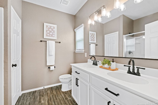 336 Salz, San Antonio, TX 78260 - bathroom with double vanity, a stall shower, and wood finished floors