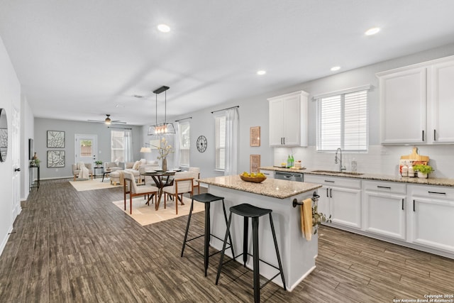 336 Salz, San Antonio, TX 78260 - kitchen with white cabinets, healthy amount of natural light, a kitchen breakfast bar, dark wood finished floors, and recessed lighting