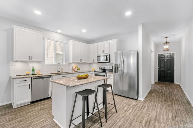 336 Salz, San Antonio, TX 78260 - kitchen with stainless steel appliances, light wood-type flooring, decorative backsplash, white cabinets, and recessed lighting