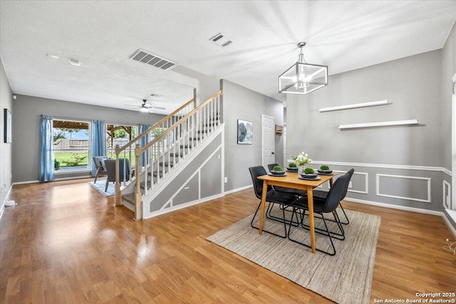 3607 Mill Mdw, San Antonio, TX 78247 - dining space with stairway, wood finished floors, a chandelier, and ceiling fan