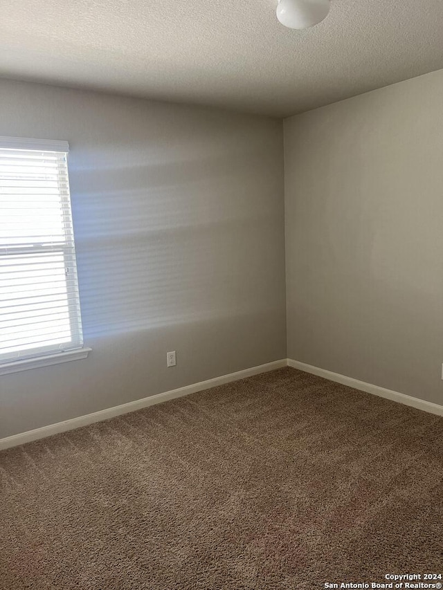2649 Mccrae, New Braunfels, TX 78130 - carpeted empty room with baseboards and a textured ceiling