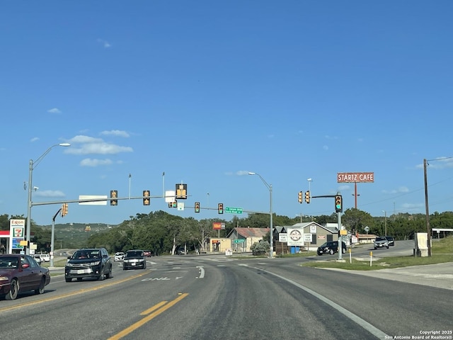 113 Creekview, Canyon Lake, TX 78133 - view of asphalt street featuring traffic lights and traffic signs