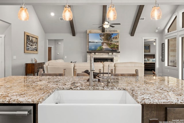 744 E Rio Azule, Pipe Creek, TX 78063 - kitchen with open floor plan, ceiling fan, light stone counters, and a premium fireplace