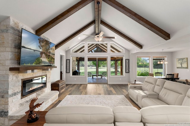 744 E Rio Azule, Pipe Creek, TX 78063 - living room with wood finished floors, ceiling fan, beamed ceiling, a fireplace, and high vaulted ceiling