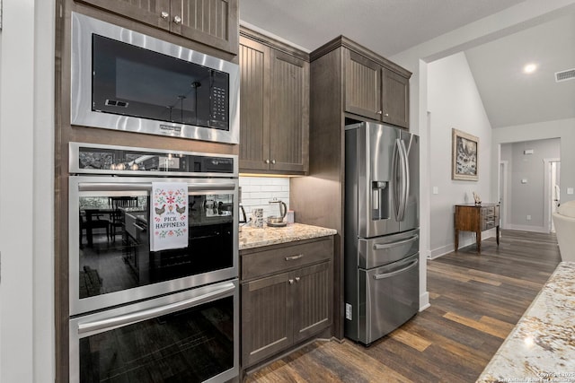 744 E Rio Azule, Pipe Creek, TX 78063 - kitchen with appliances with stainless steel finishes, dark wood-style flooring, dark brown cabinetry, lofted ceiling, and backsplash