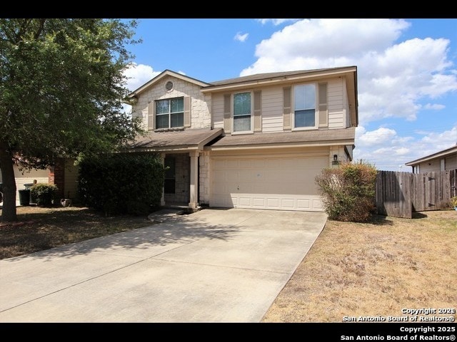 10235 Crystal, Universal City, TX 78148 - traditional home featuring a garage, driveway, and stone siding