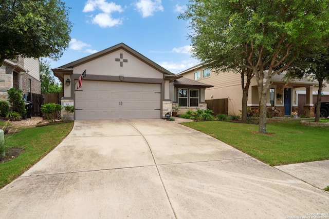 302 Pettigrew, Buda, TX 78610 - view of front of home featuring stucco siding, driveway, a garage, and stone siding