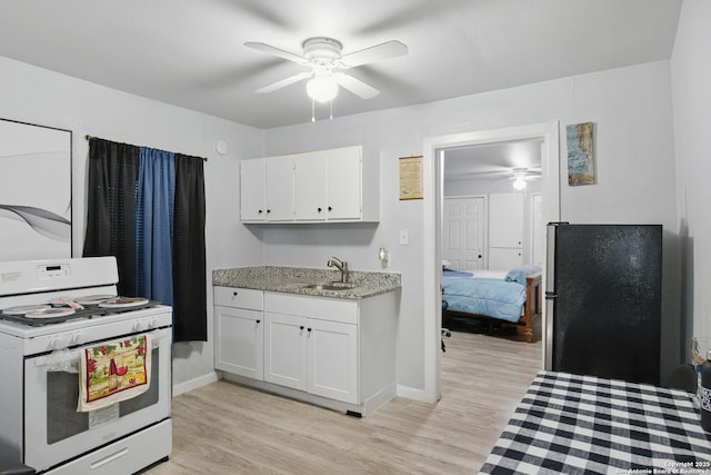 1105 Delgado St, San Antonio, TX 78207 - kitchen featuring gas range gas stove, ceiling fan, white cabinetry, and light wood finished floors