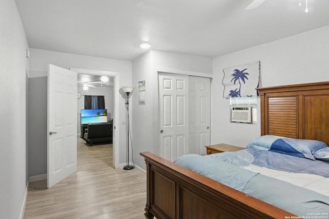 1105 Delgado St, San Antonio, TX 78207 - bedroom with light wood-style floors, a closet, ceiling fan, and cooling unit