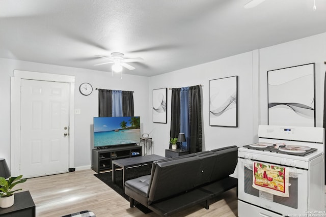 1105 Delgado St, San Antonio, TX 78207 - living room featuring a ceiling fan and light wood-type flooring
