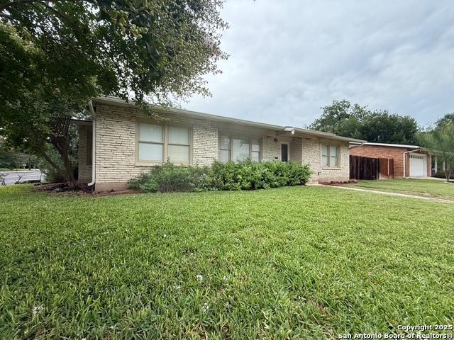 403 E Nottingham, San Antonio, TX 78209 - ranch-style home with an attached garage, a front lawn, and brick siding