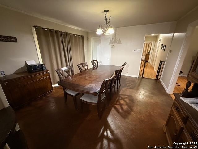 403 E Nottingham, San Antonio, TX 78209 - dining area featuring a chandelier and crown molding