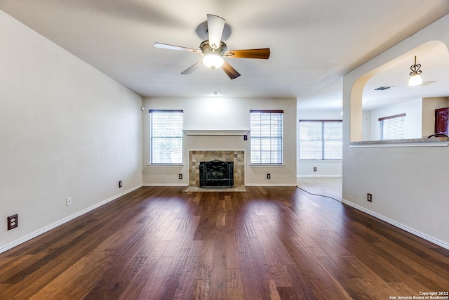 9619 Krier Vw, Converse, TX 78109 - unfurnished living room with a ceiling fan, healthy amount of natural light, wood finished floors, and a fireplace with flush hearth