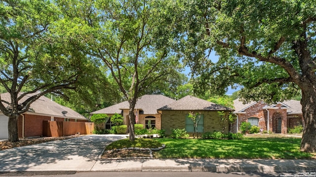 2430 Burning Trl, San Antonio, TX 78232 - view of front of house with concrete driveway, brick siding, and a shingled roof