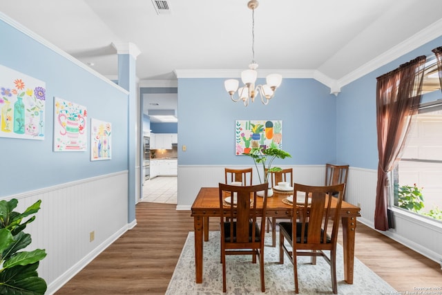 2430 Burning Trl, San Antonio, TX 78232 - dining area featuring wood finished floors, wainscoting, a chandelier, and crown molding