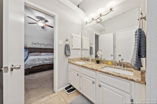 6411 Gray Rdg, San Antonio, TX 78233 - full bath featuring double vanity, ensuite bathroom, a ceiling fan, and tile patterned floors