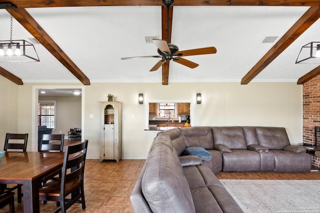 1373 County Road 373, Uvalde, TX 78801 - living area with beamed ceiling, a ceiling fan, light tile patterned flooring, and ornamental molding