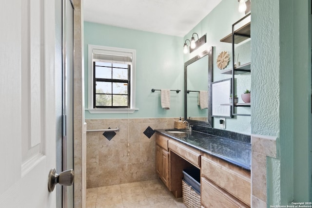 1373 County Road 373, Uvalde, TX 78801 - full bath featuring vanity, tile patterned floors, tile walls, and wainscoting
