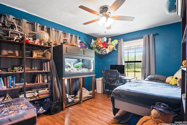 1373 County Road 373, Uvalde, TX 78801 - bedroom featuring wood finished floors and a ceiling fan