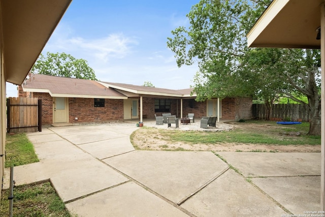 1373 County Road 373, Uvalde, TX 78801 - back of house with brick siding, a patio area, and outdoor lounge area