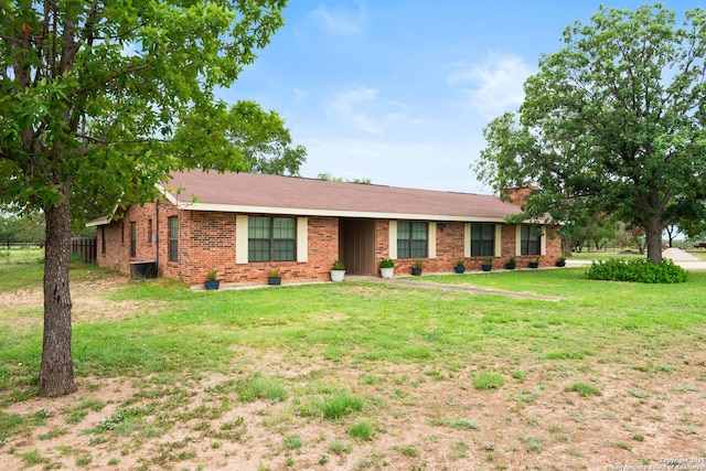 1373 County Road 373, Uvalde, TX 78801 - ranch-style home with a front yard and brick siding