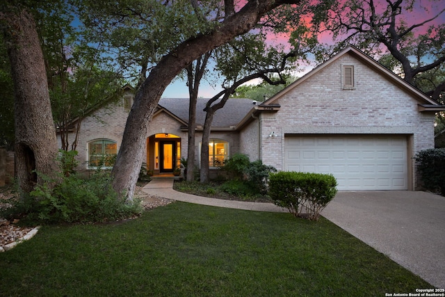 2326 Blackoak Bnd, San Antonio, TX 78248 - view of front of home with brick siding, an attached garage, concrete driveway, and a lawn