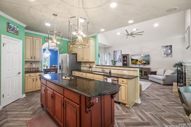 2326 Blackoak Bnd, San Antonio, TX 78248 - kitchen with appliances with stainless steel finishes, open floor plan, a peninsula, cream cabinets, and a chandelier