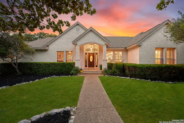 608 Kendall Pkwy, Boerne, TX 78015 - view of front facade featuring brick siding, a front lawn, and a shingled roof