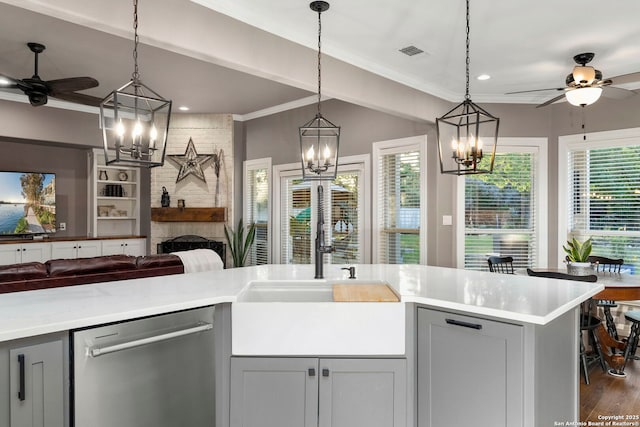 608 Kendall Pkwy, Boerne, TX 78015 - kitchen with stainless steel dishwasher, a ceiling fan, a chandelier, open floor plan, and ornamental molding
