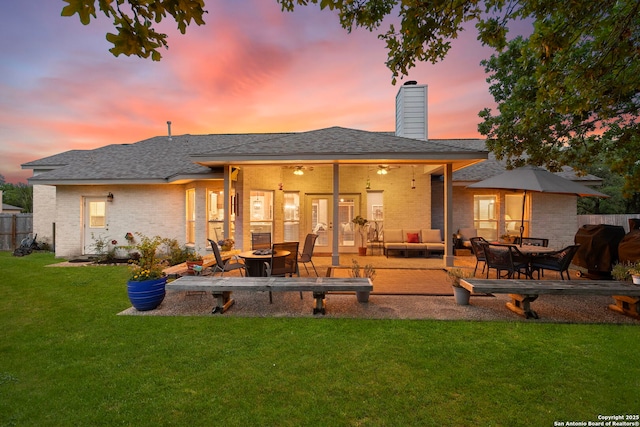 608 Kendall Pkwy, Boerne, TX 78015 - back of property with brick siding, a patio, an outdoor hangout area, and a chimney