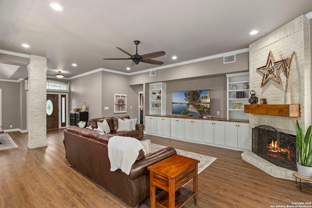 608 Kendall Pkwy, Boerne, TX 78015 - living room with ornate columns, ornamental molding, a fireplace, recessed lighting, and ceiling fan
