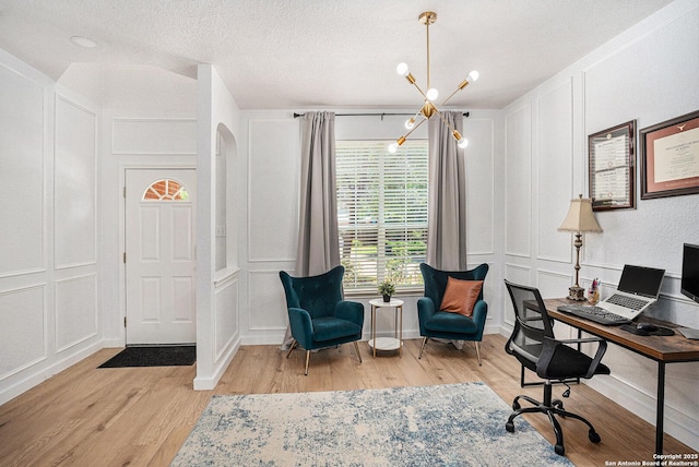 13812 Riverbank Pass, Helotes, TX 78023 - office space featuring a decorative wall, a chandelier, light wood-style floors, a textured ceiling, and arched walkways