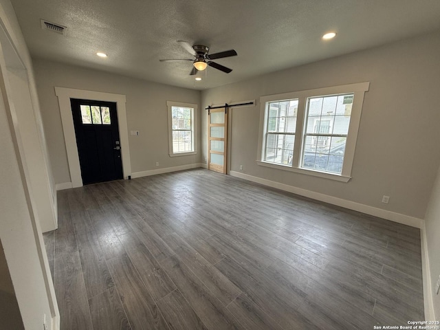 206 E Lambert, San Antonio, TX 78204 - foyer featuring a barn door, a ceiling fan, recessed lighting, dark wood-type flooring, and a textured ceiling