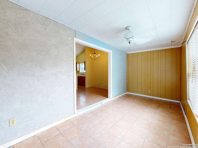 3415 Twining, San Antonio, TX 78211 - spare room featuring a chandelier, light tile patterned floors, and wooden walls
