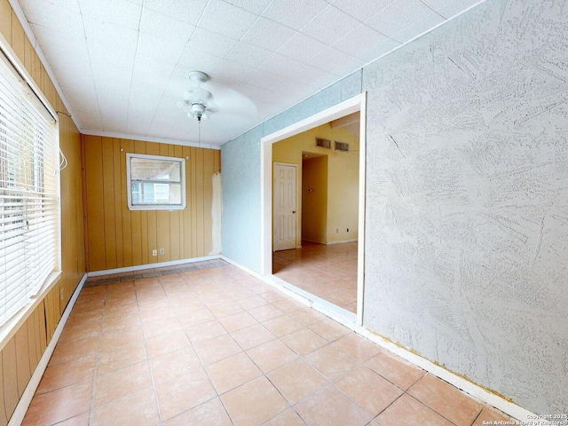 3415 Twining, San Antonio, TX 78211 - spare room with light tile patterned floors, wood walls, and ceiling fan