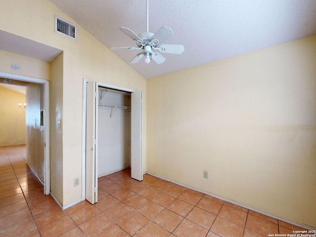 3415 Twining, San Antonio, TX 78211 - unfurnished bedroom with lofted ceiling, light tile patterned floors, a closet, a textured ceiling, and a ceiling fan