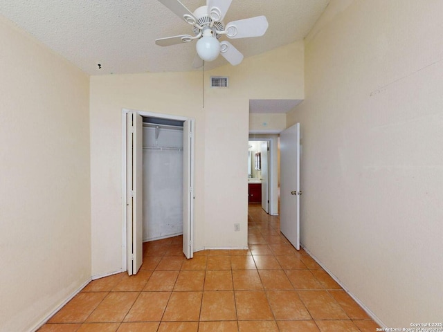 3415 Twining, San Antonio, TX 78211 - unfurnished bedroom featuring vaulted ceiling, light tile patterned flooring, a ceiling fan, and a closet
