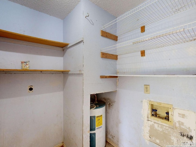 3415 Twining, San Antonio, TX 78211 - washroom featuring hookup for a washing machine, hookup for an electric dryer, electric water heater, and a textured ceiling