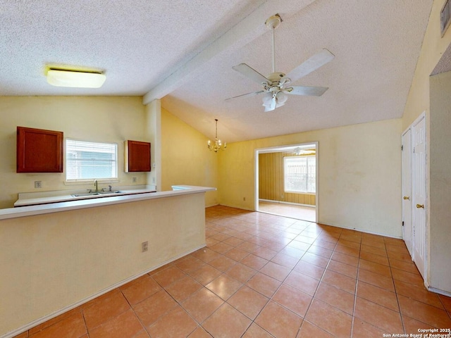 3415 Twining, San Antonio, TX 78211 - kitchen featuring plenty of natural light, a textured ceiling, a chandelier, and light tile patterned floors